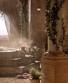 an indoor hot tub surrounded by greenery and potted plants