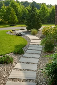 a stone path in the middle of a garden