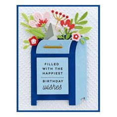 a blue mailbox with flowers in it and the words filled with the happiest birthday wishes