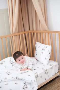 a small child laying on top of a bed