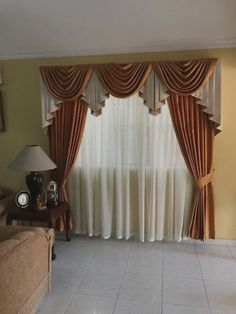 a living room filled with furniture and curtains