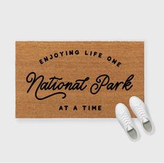 a door mat with the words enjoy life one national park at a time on it