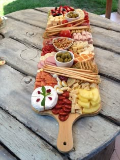 a wooden table topped with lots of different types of food on top of each other