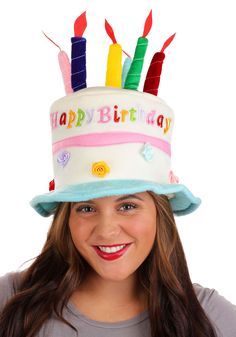 a woman wearing a birthday hat with candles on it