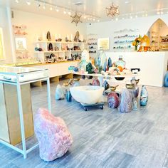 a room filled with lots of different colored vases and bowls on display next to each other