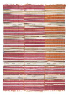 an orange and red striped rug with fringes