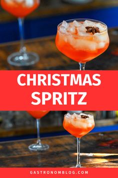 pink colored Christmas Spritz in a large wine glass on wooden table, star anise garnish