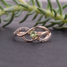 "Peridot ring, Cute ring, Multistone ring, Fine ring, Twist ring, Birthstone ring, Gemstone ring, Custom stone ring, Personalize ring WE OFFER UNLIMITED PERIOD INSTALLMENTS PLAN This is a beautiful, stunning, feminine ring that works well for all occasions, styles, and ages. You will love it! Ring information: Main stone: Peridot Approximate size: 3mm Approximate weight: 0.13ct Accent stone: Cubic zirconia Metal type: Gold Metal stamp: 14k Gold Customization / Replacements It's easy to create je Green Diamond Ring Gift, Green Diamond Ring With Round Stone For Gift, Peridot Rings With Accent Stones For Anniversary, Gemstone Bypass Promise Ring, Green Gemstone Promise Ring, Green Open Cluster Ring For Promise, Peridot Birthstone Rings With Round Stones, Peridot Ring With Accent Stones, Peridot Gemstone Diamond Ring