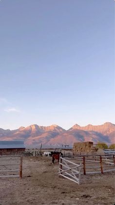 an open field with mountains in the background