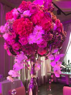 a tall vase filled with lots of pink flowers