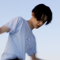 a young man riding a skateboard down a street