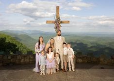 a group of people standing in front of a cross