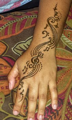 a person's hand with a henna tattoo on it