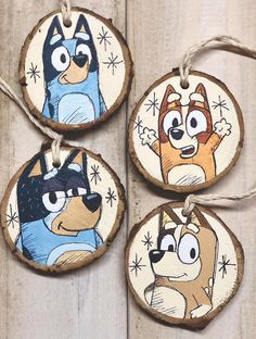 three wooden ornaments with cartoon characters on them