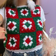 a close up of a doll wearing a crocheted granny's christmas sweater