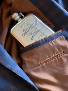 an aluminum flask in the pocket of a blue jacket