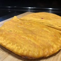 two pieces of bread sitting on top of a wooden cutting board