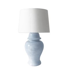 a white table lamp with a light blue base and a white shade on the top