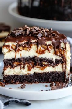 a piece of cake with chocolate and white frosting on it sitting on a plate