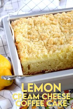 a close up of a cake in a pan with two lemons next to it