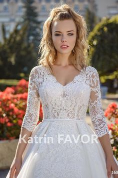 a woman in a white wedding dress posing for the camera with her hands on her hips