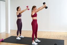 two women are doing exercises with dumbbells