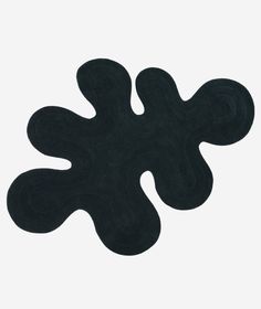 a black rug that is on top of a white surface with the shape of an object