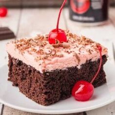 a piece of cake on a plate with cherries