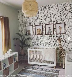 a baby's room with giraffes and zebra prints on the wall