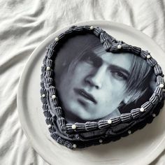 there is a cake with a picture of a boy on it and beads around the edges