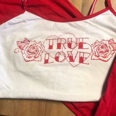 New Without Tags! All Cotton White Tank With Red Straps And Matching Pants In Red With A White Tie In Front. Inseam On Pants Is 29”, Length Of Tank From Top Of Tank (Refer To Picture) Is 16.5”. “True Love” Printed Across Chest With Two Roses. Cheap Red T-shirt For Playwear, Two Roses, Matching Pants, White Tie, White Tank, Lady In Red, True Love, Women's Intimates, Red White