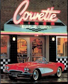 an old red car is parked in front of a bar and grill with neon signs