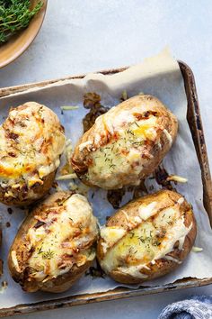 baked potatoes with cheese and herbs in a tray