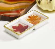 two small dishes with autumn leaves in them