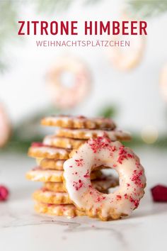 a stack of cookies with white frosting and sprinkles on top, in front of a christmas background