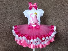 This set includes a shirt, tutu and bow! Available in sizes 3 months to 10 years. *Please be sure to include name and age at checkout* Request a custom tutu! We can do any color or color variation. All of our tutu's are beautifully sewn and double layered. They are made with yards and yards of 100% high quality diamond net nylon tulle and  soft satin ribbon with a versatile elastic waist band. Make sure to check out all the sizing charts located in the pictures. WASHING INSTRUCTIONS Please, keep it in mind that T-shirts and tutus are handcrafted and decorations need a special care treatment, that's why I recommend only hand wash or over wash stains sparingly and let air dry. If you have any questions or concerns fell free to message me!  SHIPPING : We usually ship in 3 business days ( plea Peach Birthday Outfit, Peach 1st Birthday, Princess Peach Birthday, Princess Peach Party, Kid Birthday Outfits, Peach Birthday, Birthday Costume, Costume Princess, 1st Birthday Tutu