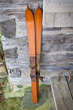 a pair of skis leaning against a wooden wall