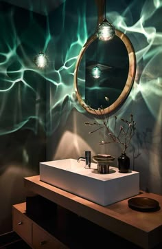 a bathroom with a sink, mirror and lights on the wall in it's corner