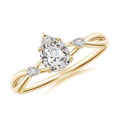 a yellow gold ring with an oval cut diamond and two pear shaped diamonds on the band