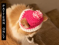 a cat wearing a pink and white crocheted hat