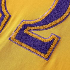 T shirt. true to size chenille embroidered logo Yellow Crew Neck Tops With Embroidered Logo, Varsity Cotton T-shirt With Letter Embroidery, Sporty Custom Embroidery T-shirt For Streetwear, Sporty T-shirt With Custom Embroidery, Yellow Cotton Top With Embroidered Logo, Varsity Crew Neck T-shirt With Letter Embroidery, Custom Embroidery Crew Neck T-shirt For College, Crew Neck Tops With Embroidered Patch For Streetwear, College Short Sleeve T-shirt With Letter Embroidery