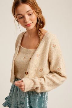 -Available in Sage & Oatmeal -Cami and cardigan sweater set -Cozy fur knit sweater -Flower embroidered -Crop length cami -Button down crop cardi -Content: 50% Nylon 25% Polyester 25% Acrylic -Imported -Model is 5' 10" 32-26-35 and wearing a size Small Cropped Cardigan Outfit, Flower Cardigan, Fairy Clothes, Black Femininity, Cropped Cardigan Sweater, Embroidered Cardigan, Floral Cardigan, Cardigan Outfits, Shopping Tips