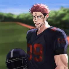 a man with red hair wearing a football uniform and holding a helmet in his hand