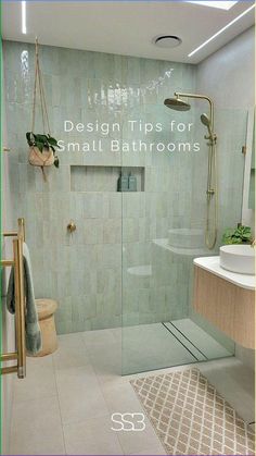 a bathroom with a glass shower door and tiled floor