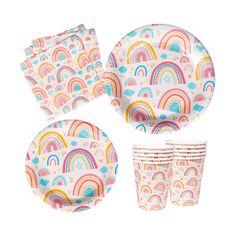 a set of paper plates and cups with rainbows on them