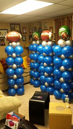 balloons are stacked on top of each other in the shape of footballs and balls