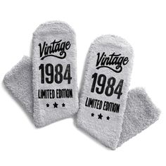 two white oven mitts with the words vintage and limited written on them in black ink