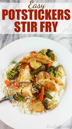 a white plate topped with chicken and veggies next to rice on top of a marble counter