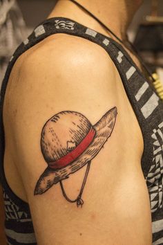 a woman's arm with a hat on it and a knife in the middle