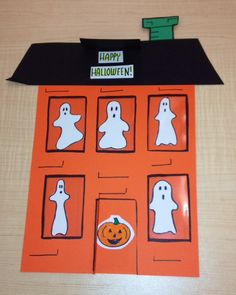 an orange halloween card with ghost cutouts on it